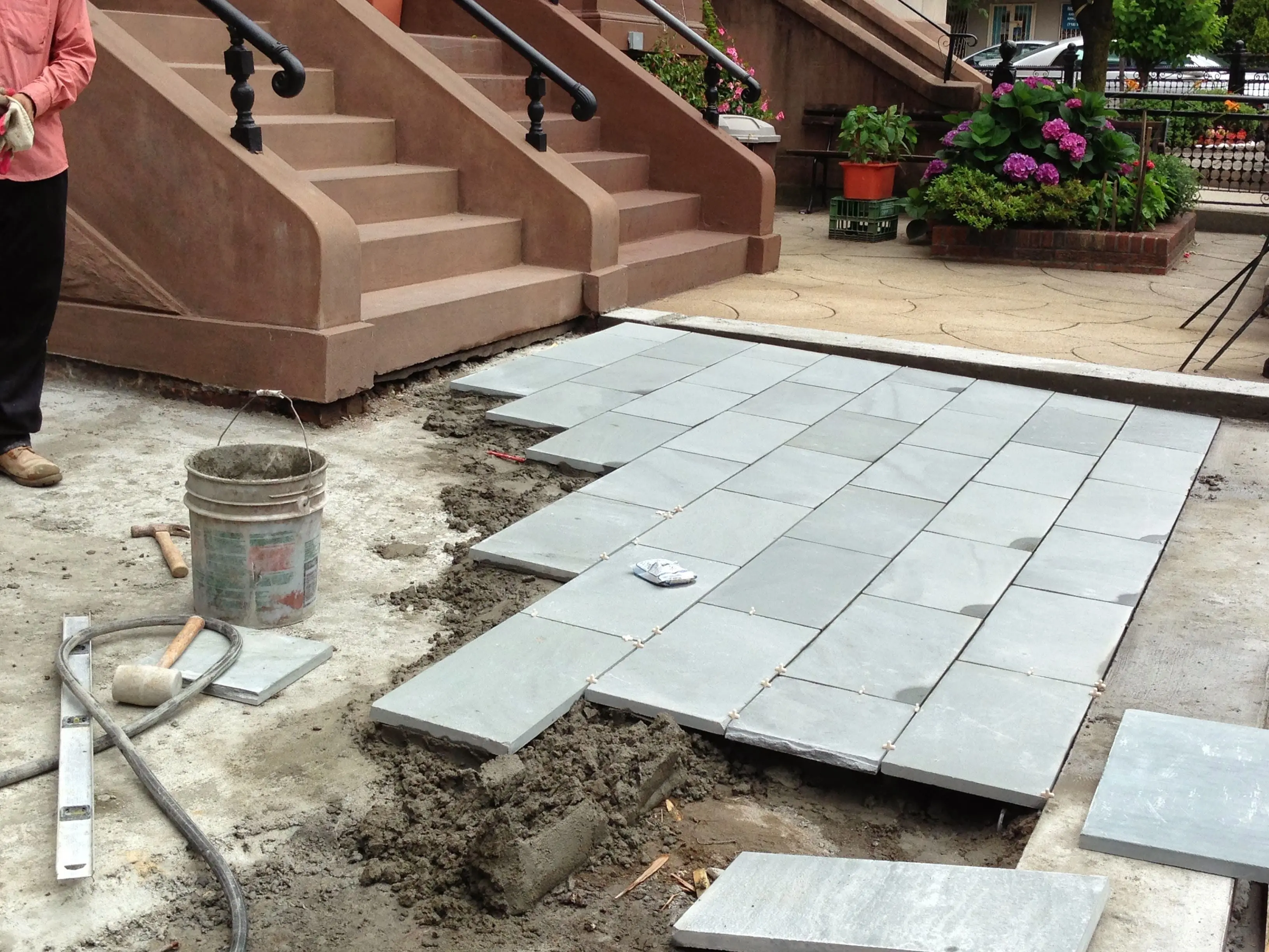 Expert paving crew installing decorative concrete and brick in Brooklyn, NYC