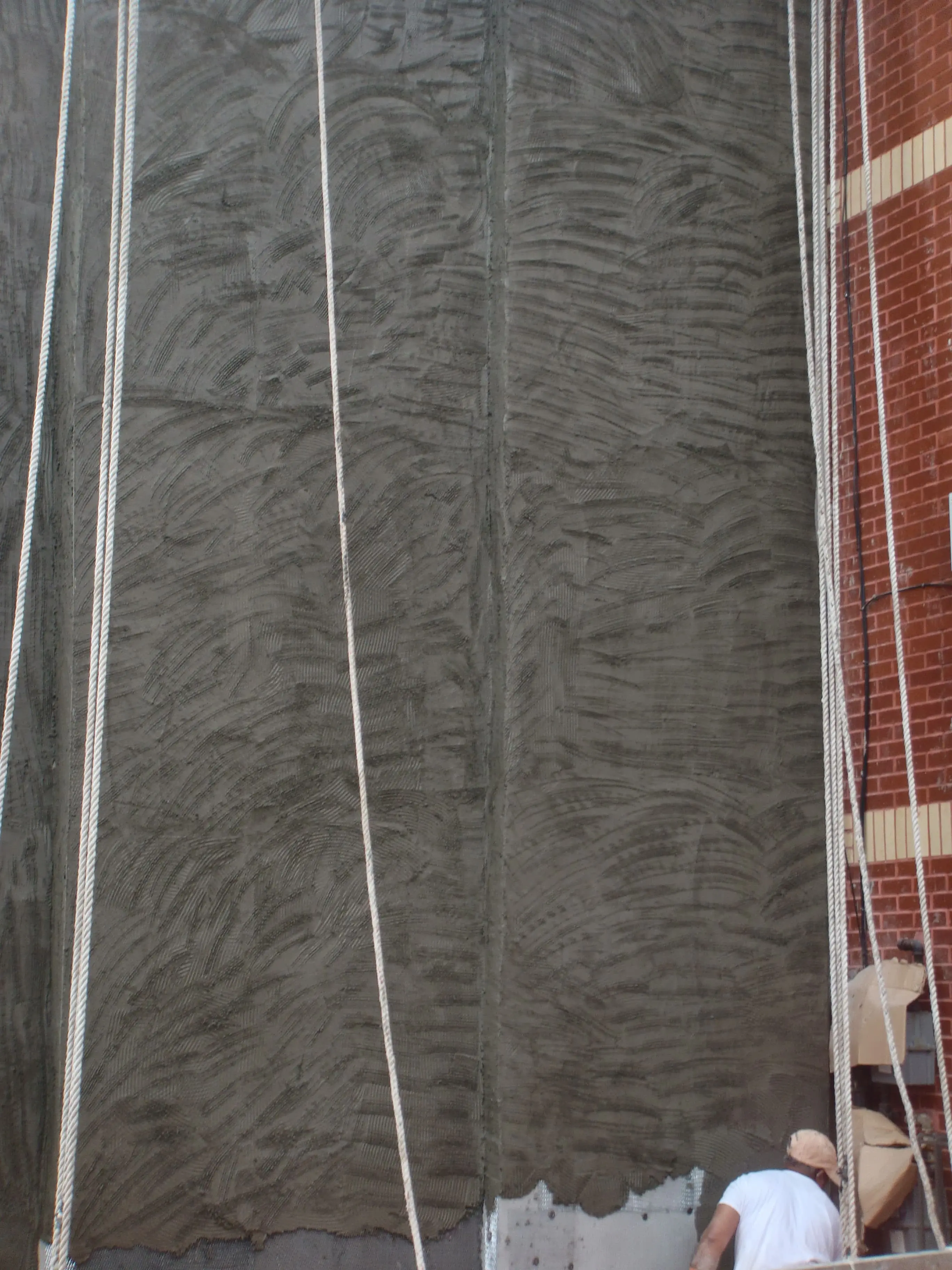 Before masonry work showing damaged wall surface prior to brick and CMU restoration in NYC